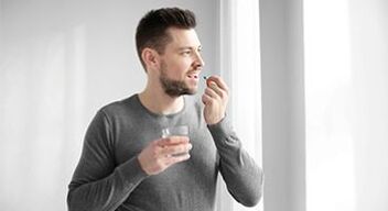a man takes medication to treat prostatitis